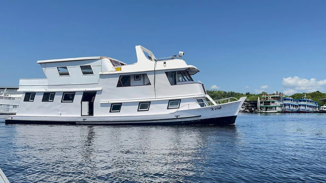 Traditional wooden riverboat moored on a quiet Amazon side-channel
