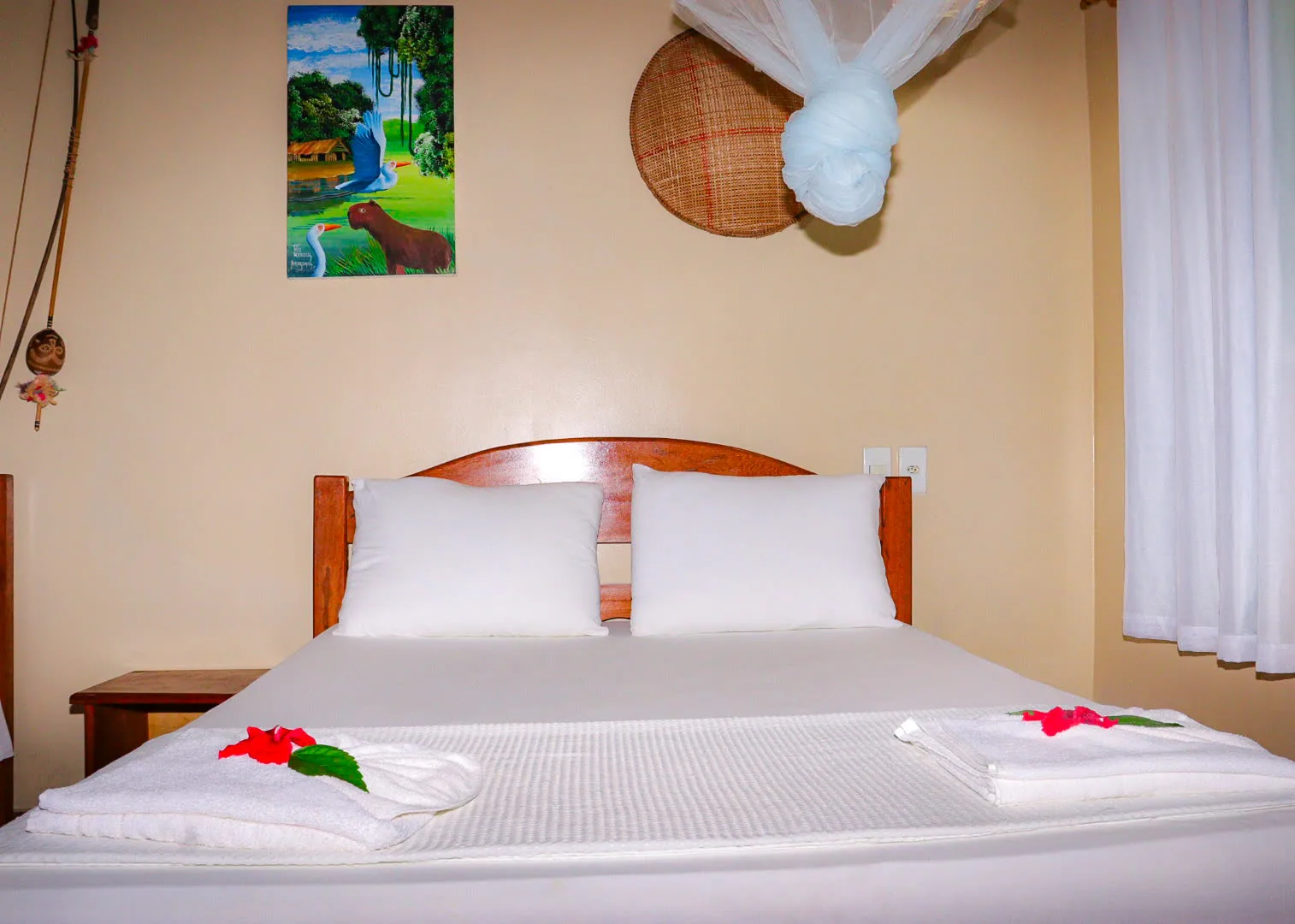 Standard lodge room with two beds and a mosquito net