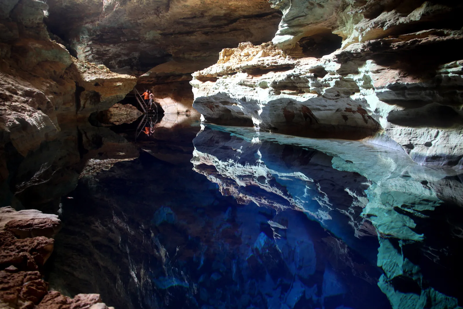 Sunlight falling as a beam into the blue underground pool of Poço Azul