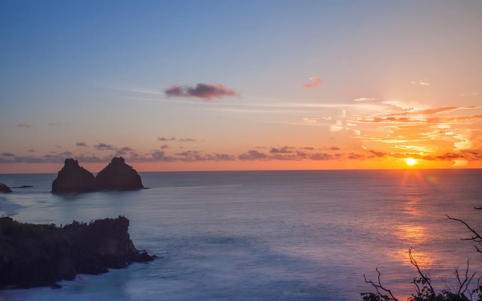 Sunset behind the twin rock of Morro Dois Irmãos on Fernando de Noronha