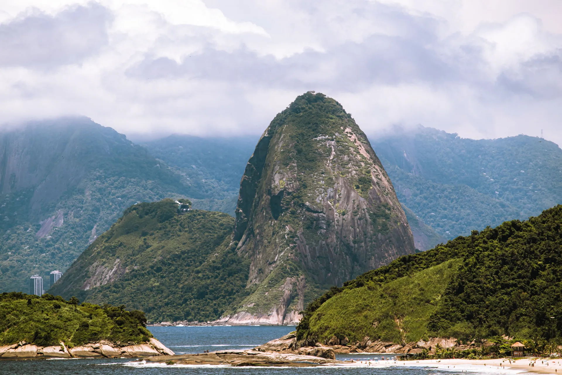 Sugarloaf Mountain rising over the bay and a quiet beach in Rio de Janeiro