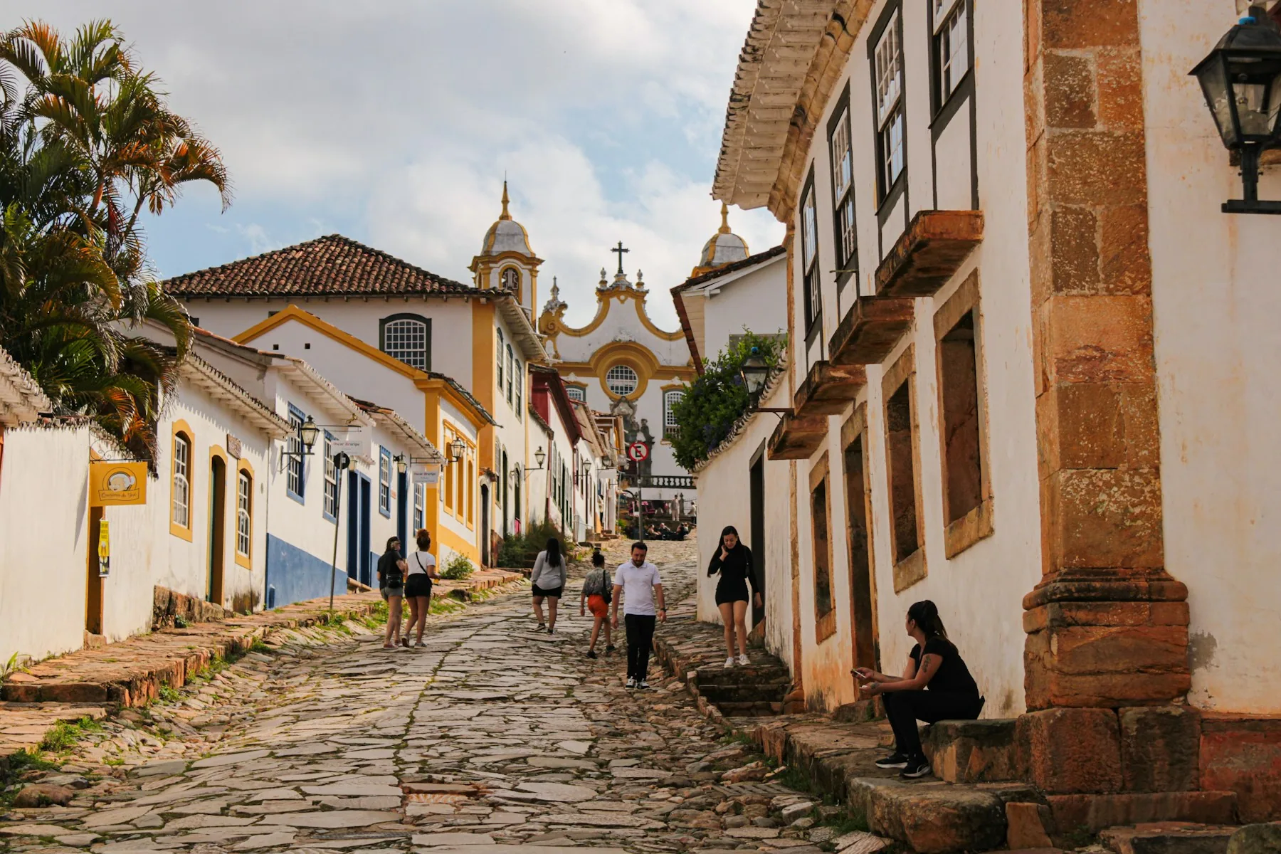 A cobbled street of pastel colonial houses in a historic town centre