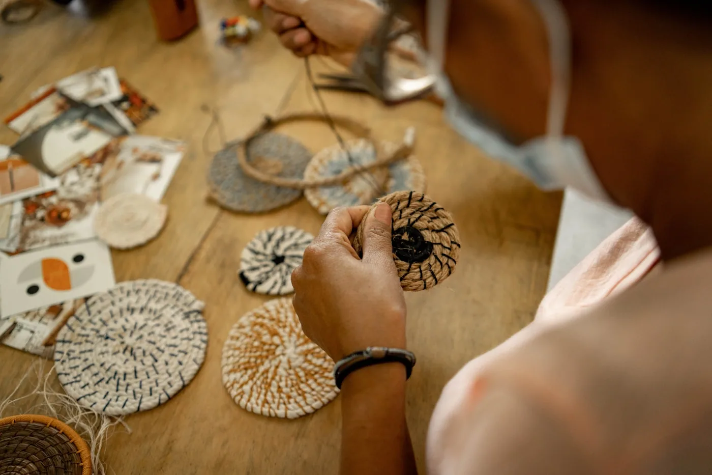 An artisan’s hands at work on a handmade piece at the bench