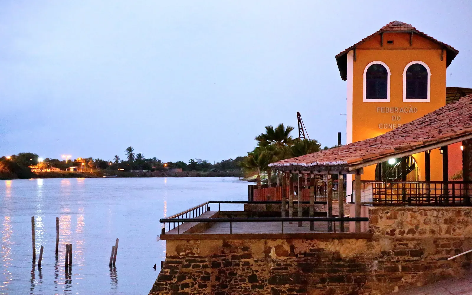 The old riverside warehouses of Porto das Barcas glowing at dusk