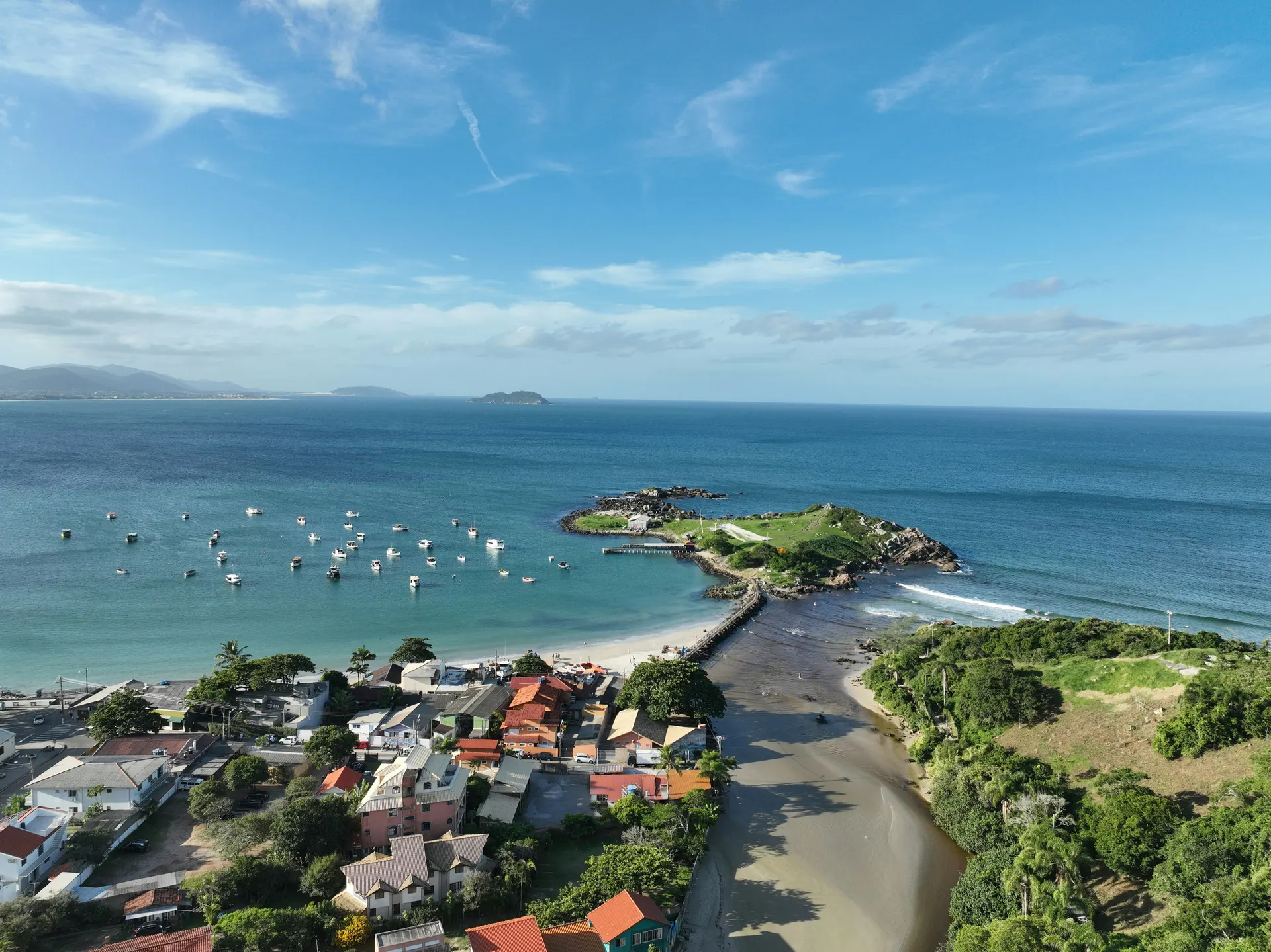 The green Lagoa da Conceição lagoon ringed by hills, seen from a hilltop lookout