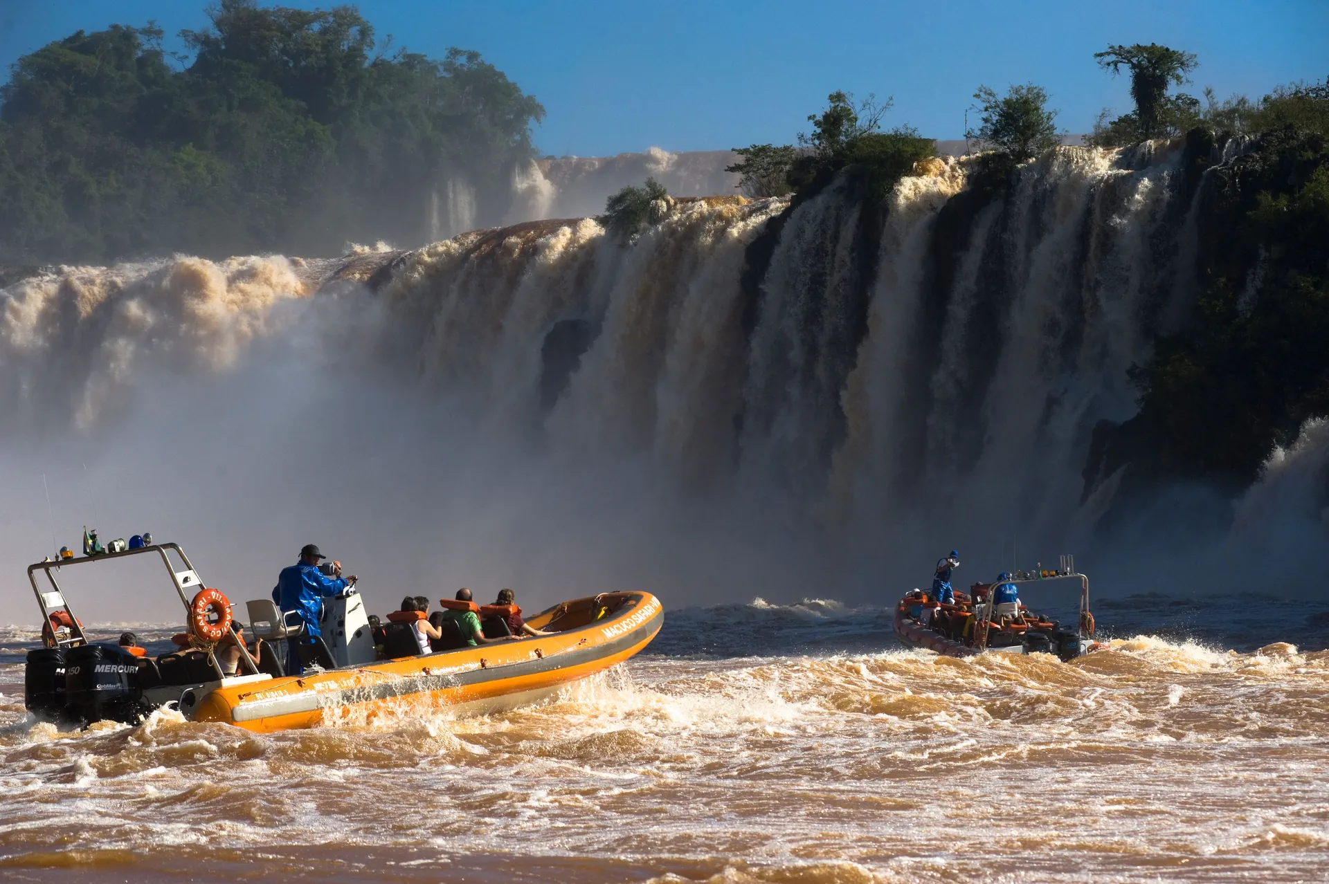 Visitors on a spray-soaked walkway close to the base of the Iguaçu Falls