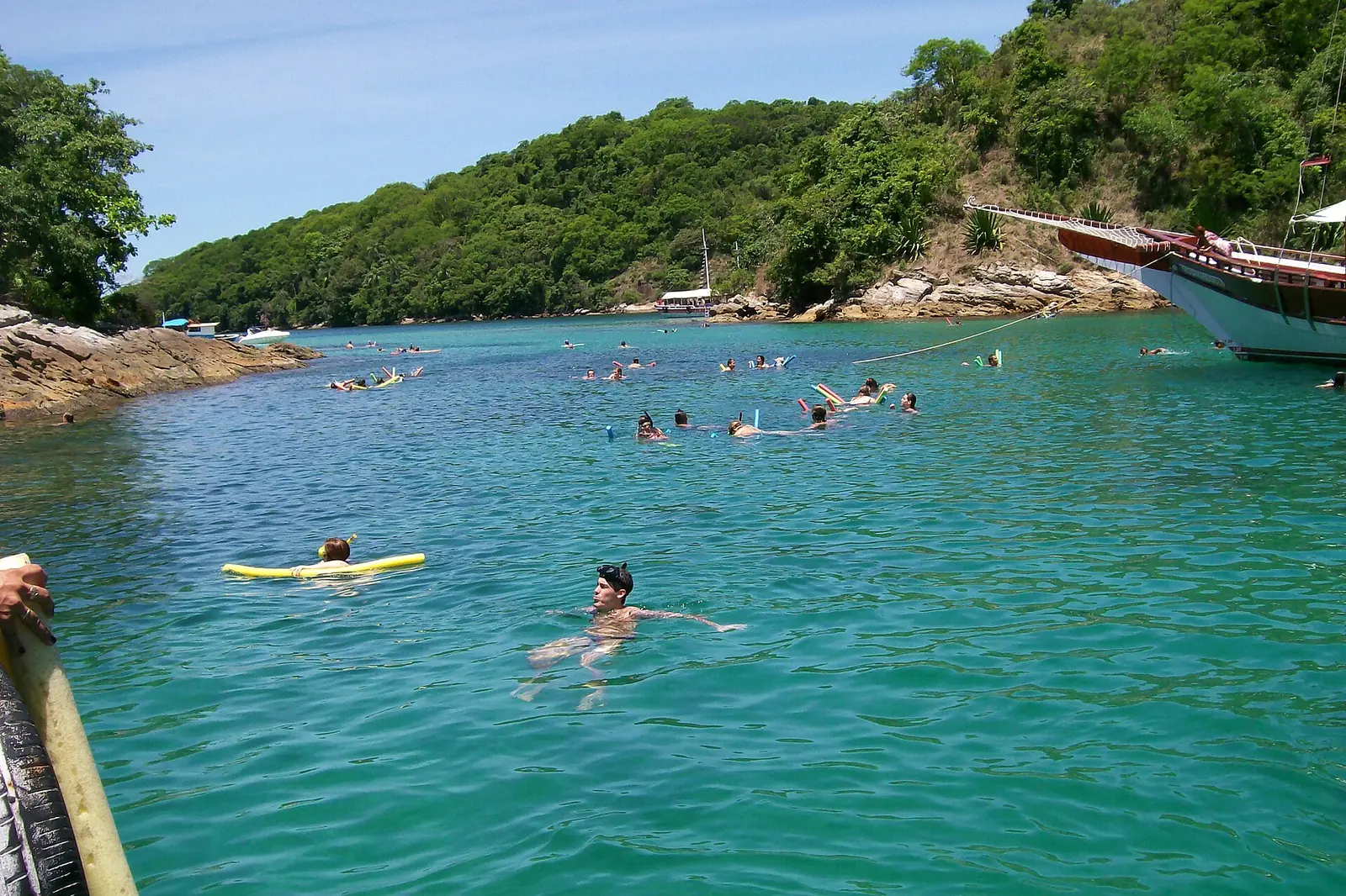 Snorkellers in the glass-clear turquoise water of the Blue Lagoon off Ilha Grande