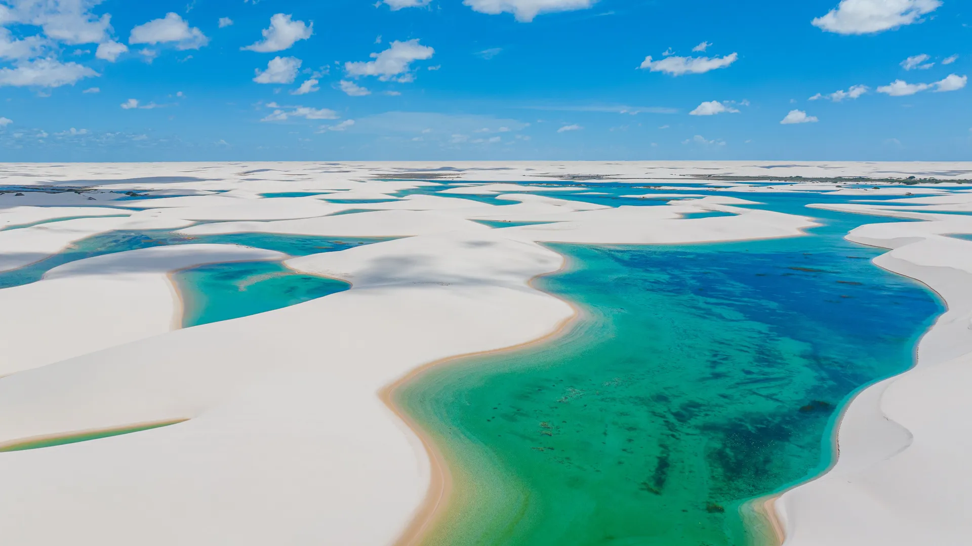 Aerial view of the white dunes and turquoise lagoons of the Lençóis Maranhenses