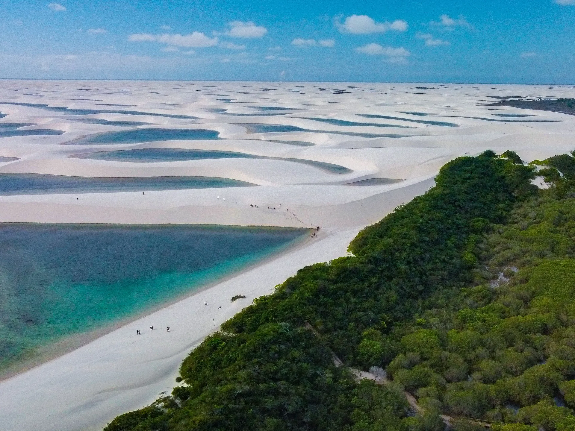 A lagoon glowing between white dunes in golden late-afternoon light
