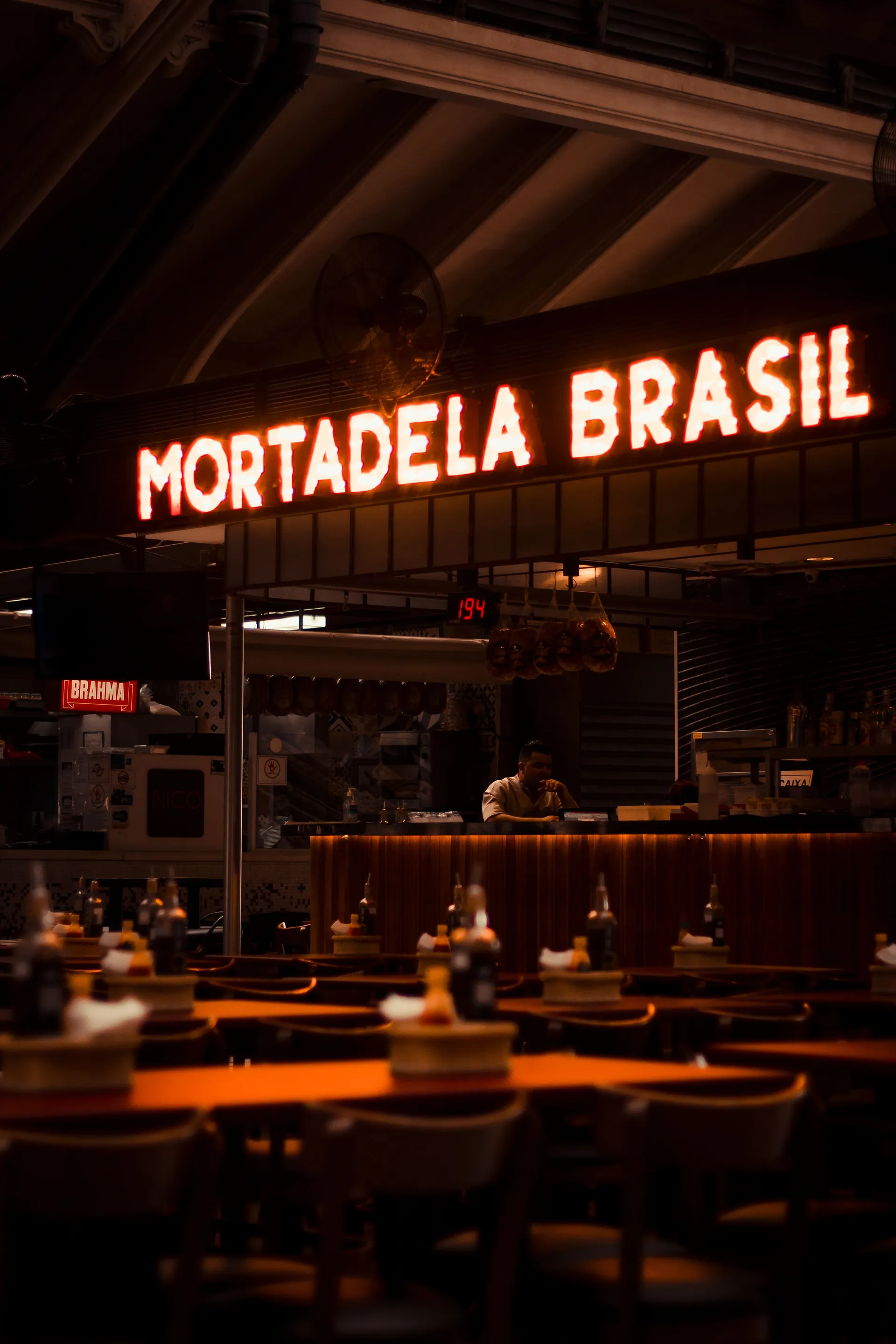 The neon-lit “Mortadela Brasil” counter inside São Paulo’s Mercado Municipal